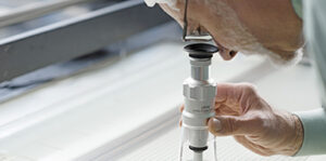 Employee of the Etching Group looking through a microscope